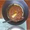 Bokomo Maltabella Sorghum porridge in a black bowl with a spoon.